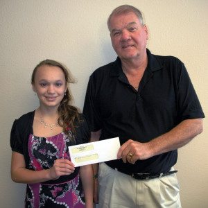 George Gram II, General Manager, SOC Nevada LLC, recently presented a check to assist Sierra Walker, a student at Mineral County High School, to help her