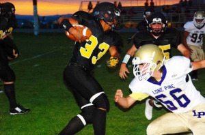 Mineral County High running back Michael Smith cuts through the Lone Pine defense in the Serpents 62-14 win Friday night.