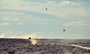 Tanya Bunch A Best in the Desert racer rides over a hill in Mineral County Friday afternoon as a pair of helicopters follow the track. Jason Voss won the 530 plus mile event across the Nevada desert for the third straight year.