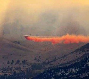 An airliner dumps retardent on a wildfire that is burning in the June Lake area near Lee Vining, Calif..
