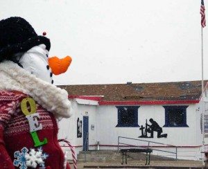 Sheri Samson Noel the snowman stands outside of Jerry’s Barber Shop on E Street in Hawthorne. 
